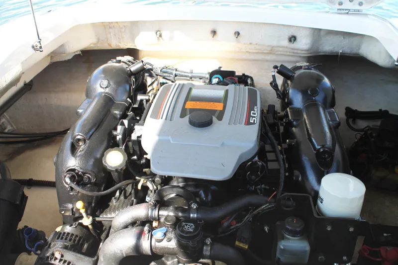 Slide: The Image of Engine compartment of 2015 Chaparral 224 Sunesta boat, showcasing a 5.0L engine. - 51