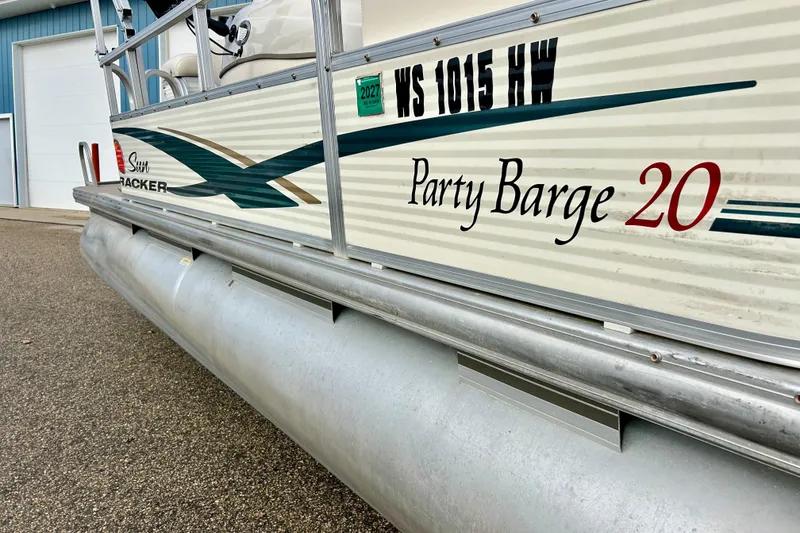 Slide: The Image of 2010 Sun Tracker Party Barge 20 Classic Series pontoon boat, side view with branding. - 2