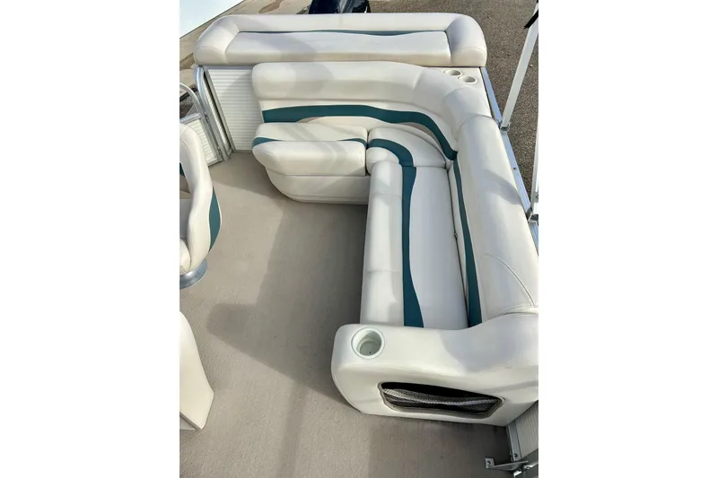 Slide: The Image of 2010 Sun Tracker Party Barge 20 Classic Series interior seating with white and teal upholstery. - 20