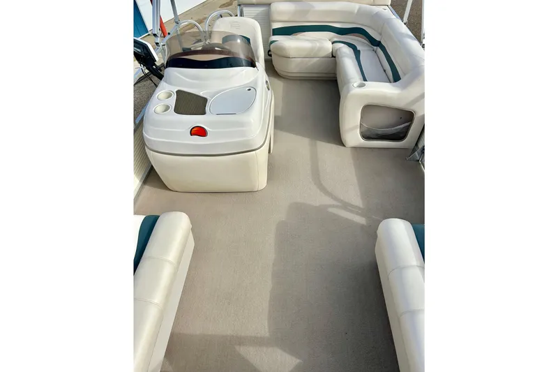 Slide: The Image of 2010 Sun Tracker Party Barge 20 Classic Series interior with plush seating and helm. - 29
