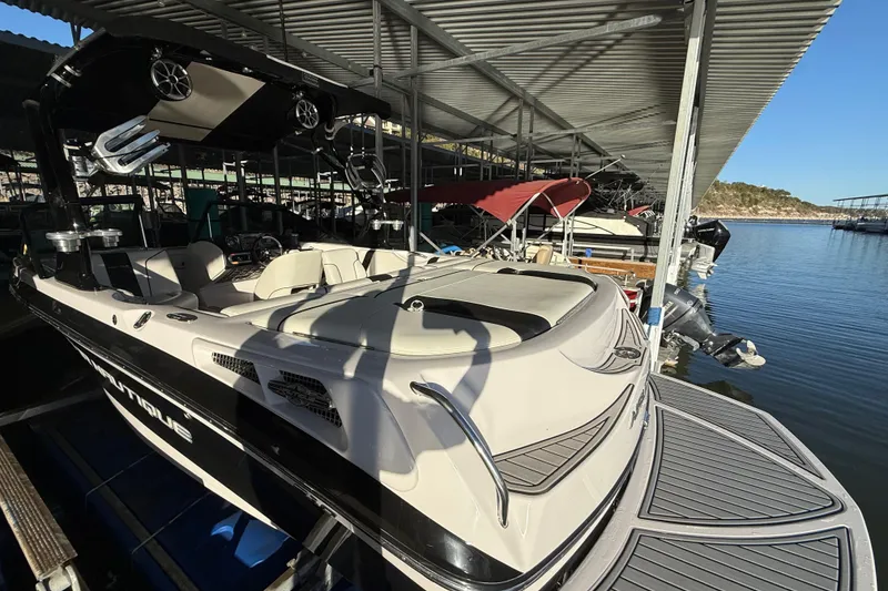 Slide: The Image of 2010 Nautique Super Air Nautique 210 boat docked in marina, interior view. - 15