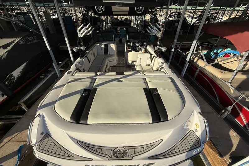 Slide: The Image of 2010 Nautique Super Air Nautique 210 interior with plush seating and modern dashboard. - 17