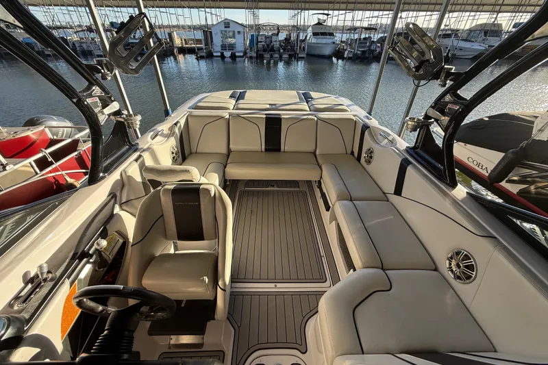 Slide: The Image of 2010 Nautique Super Air Nautique 210 dashboard with steering wheel and gauges. - 21