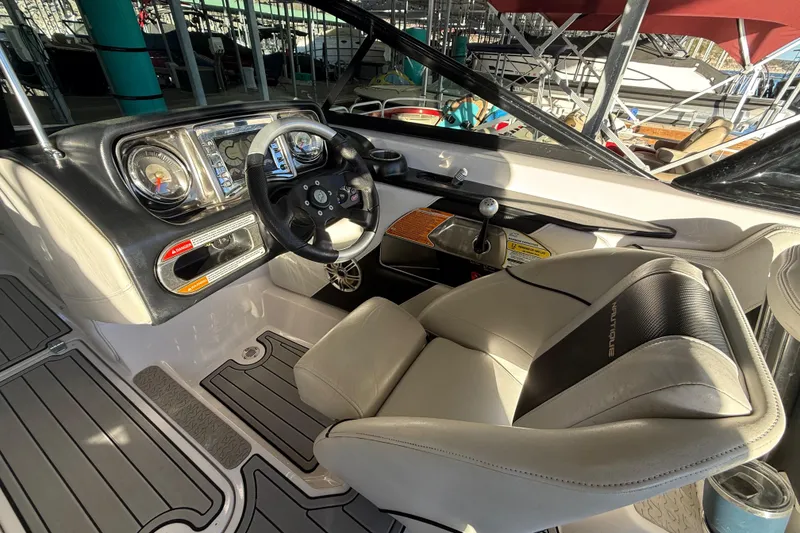 Slide: The Image of 2010 Nautique Super Air Nautique 210 interior with seating and cup holders. - 22