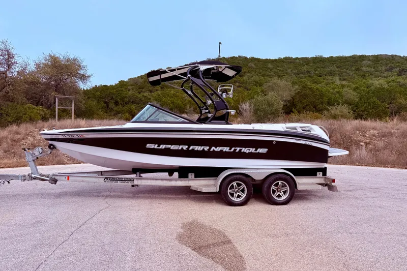 Slide: The Image of 2010 Nautique Super Air Nautique 210 boat on trailer, parked outdoors. - 8