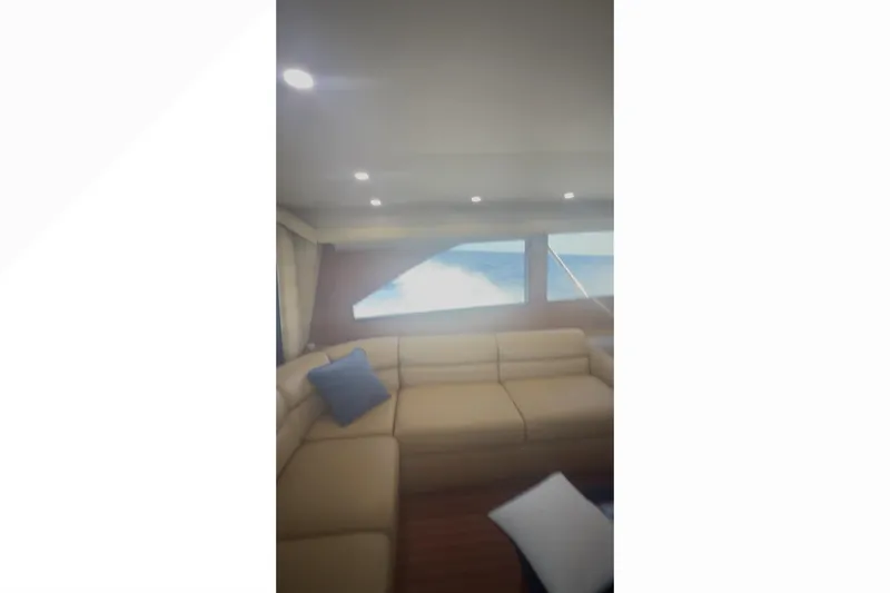 Slide: The Image of Luxurious interior of 2003 Viking 65 Convertible yacht with beige seating and ocean view. - 10