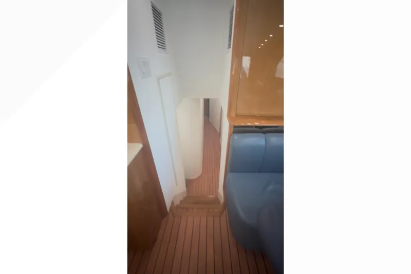 Slide: The Image of Interior view of 2003 Viking 65 Convertible yacht with wooden flooring and seating. - 11