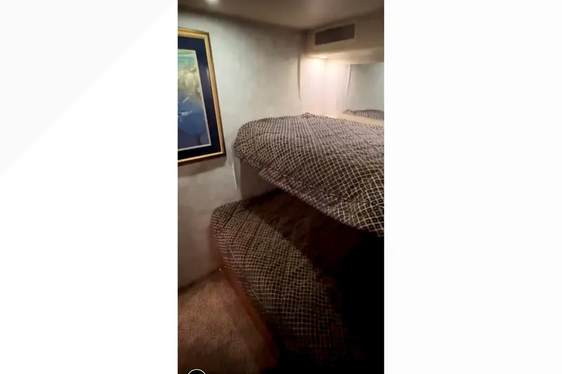 Slide: The Image of Interior of 2003 Viking 65 Convertible yacht with bunk beds and framed artwork. - 13