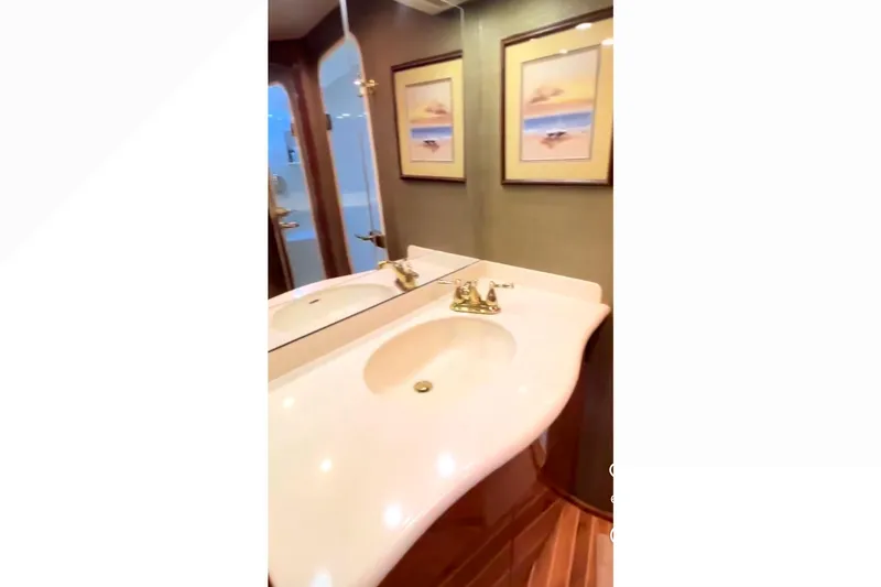 Slide: The Image of Luxurious bathroom interior of 2003 Viking 65 Convertible yacht with elegant sink and artwork. - 16