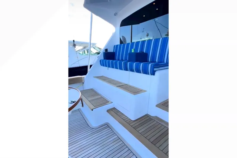 Slide: The Image of 2003 Viking 65 Convertible yacht with striped seating and wooden steps. - 8