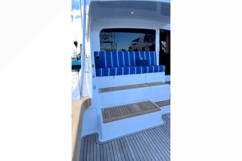 Slide: The Image of 2003 Viking 65 Convertible yacht with striped seating and wooden steps. - 9