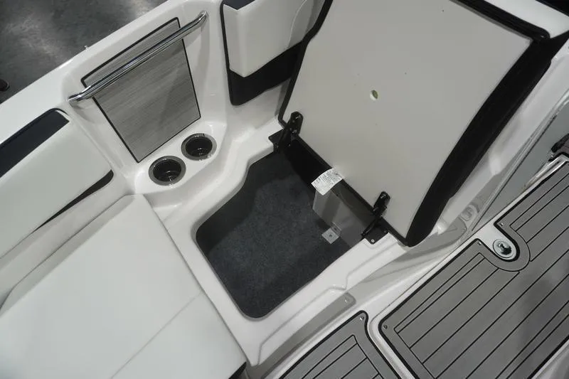 Slide: The Image of 2024 Yamaha Boats 222SD interior storage compartment with cup holders and sleek design. - 15