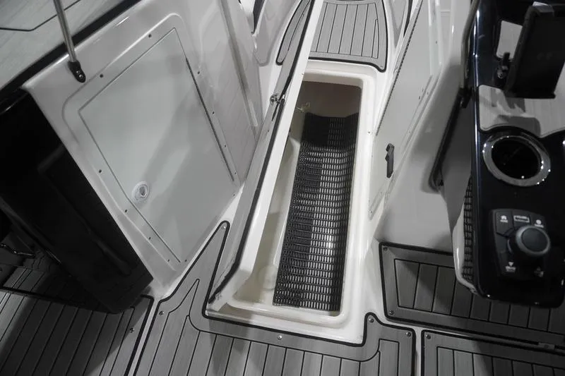 Slide: The Image of 2024 Yamaha Boats 222SD storage compartment with open hatch, showcasing sleek interior design. - 16