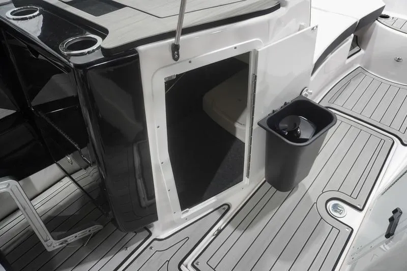 Slide: The Image of 2024 Yamaha Boats 222SD interior with open storage compartment and sleek deck design. - 17