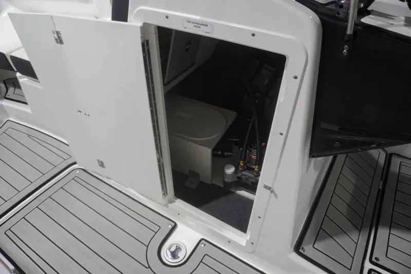 Slide: The Image of 2024 Yamaha Boats 222SD storage compartment with open hatch, showcasing interior details. - 18