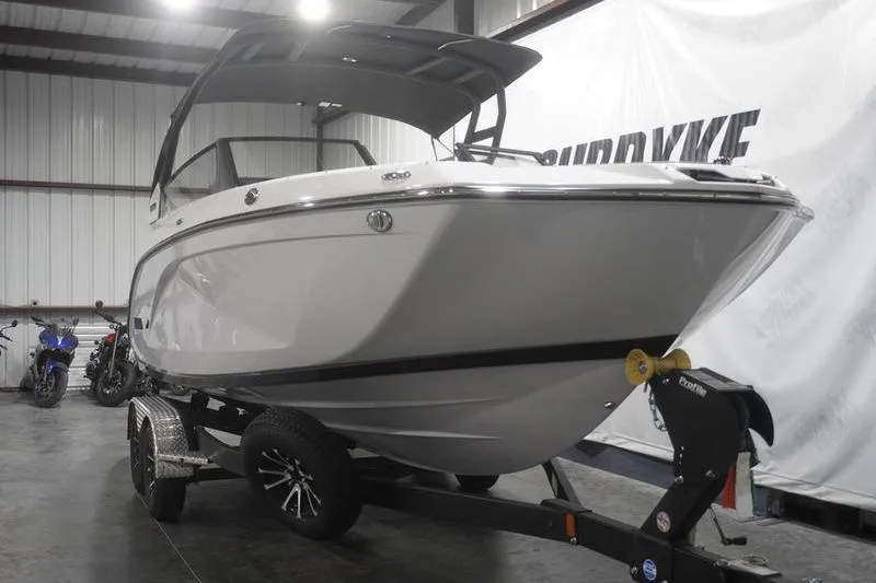 Slide: The Image of 2024 Yamaha Boats 222SD on trailer in indoor showroom. - 2