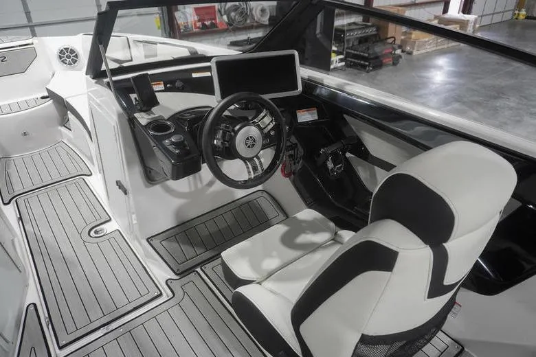 Slide: The Image of 2024 Yamaha Boats 222SD interior with modern steering, touchscreen, and sleek seating. - 20