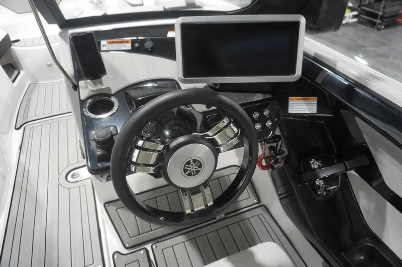Slide: The Image of 2024 Yamaha Boats 222SD dashboard with steering wheel and touchscreen display. - 21
