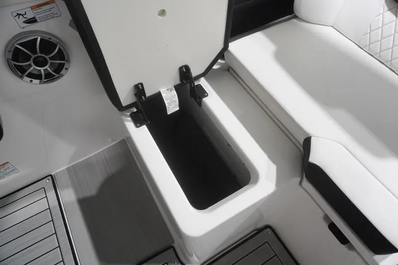 Slide: The Image of 2024 Yamaha Boats 222SD storage compartment with open lid, featuring sleek interior design. - 29