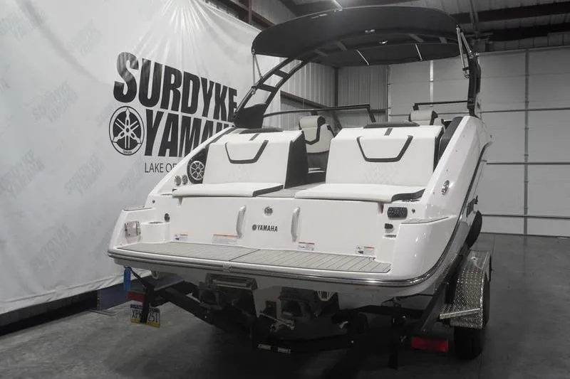 Slide: The Image of 2024 Yamaha Boats 222SD in showroom, rear view with seating and canopy. - 3