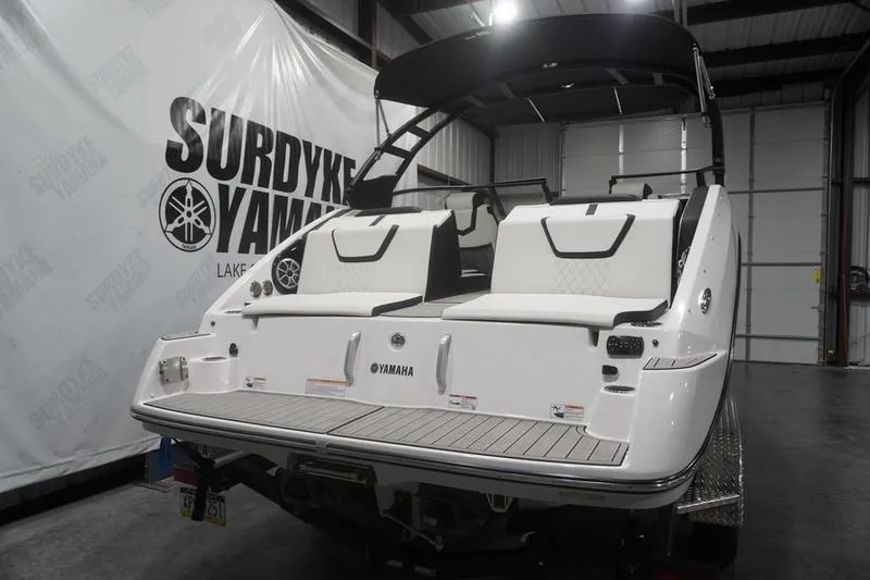 Slide: The Image of 2024 Yamaha Boats 222SD in showroom, rear view with seating and canopy. - 4