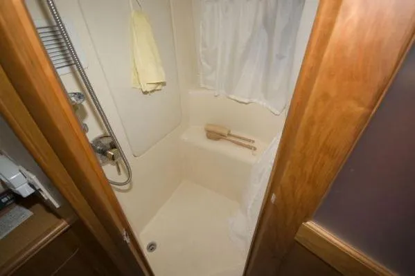 Slide: The Image of Bathroom interior of 2003 Silverton 39 Motor Yacht with shower and wooden accents. - 10