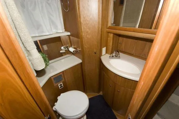 Slide: The Image of 2003 Silverton 39 Motor Yacht bathroom with wooden cabinetry and modern fixtures. - 11