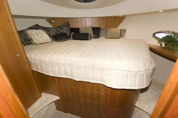 Slide: The Image of 2003 Silverton 39 Motor Yacht bedroom with cozy bed and elegant wood cabinetry. - 12