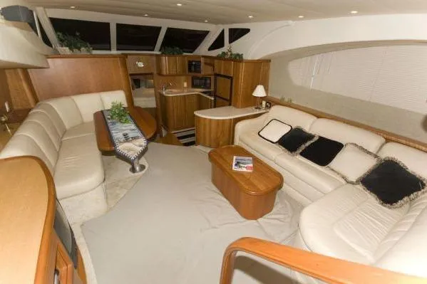 Slide: The Image of Luxurious interior of 2003 Silverton 39 Motor Yacht with elegant seating and wooden accents. - 16