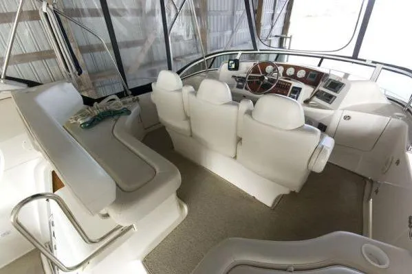 Slide: The Image of 2003 Silverton 39 Motor Yacht interior with white seating and control panel. - 5