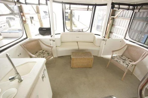 Slide: The Image of 2003 Silverton 39 Motor Yacht interior with seating area and wicker chairs. - 6