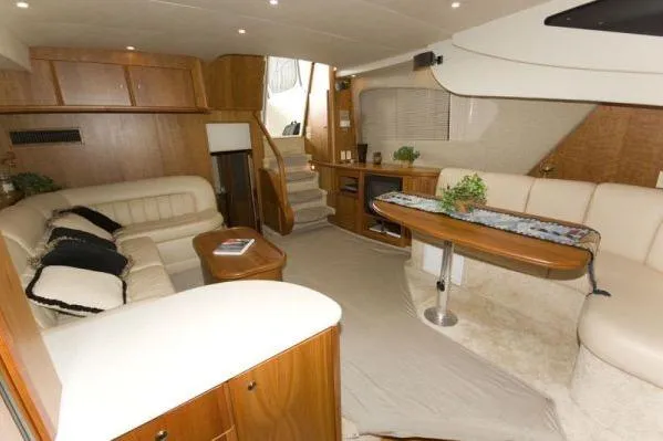 Slide: The Image of Interior of 2003 Silverton 39 Motor Yacht with elegant seating and wooden cabinetry. - 7