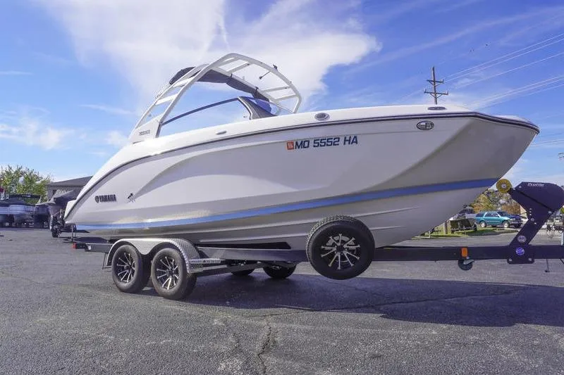 The Image of 2024 Yamaha Boats 222S on trailer, parked outdoors under blue sky. - 1
