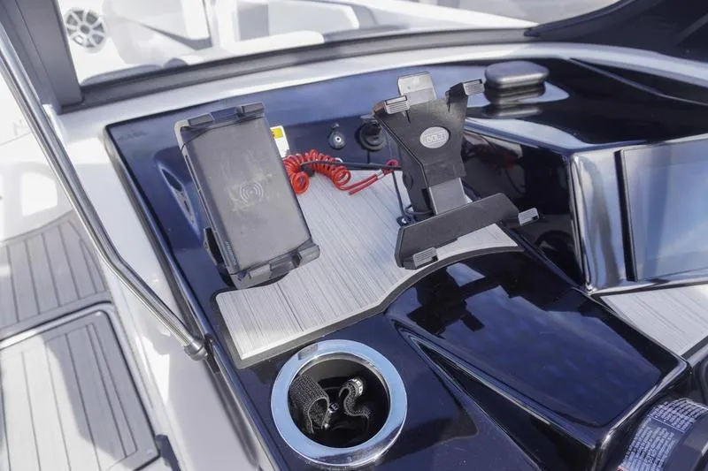 Slide: The Image of 2024 Yamaha Boats 222S dashboard with phone holders and cup holder. - 22