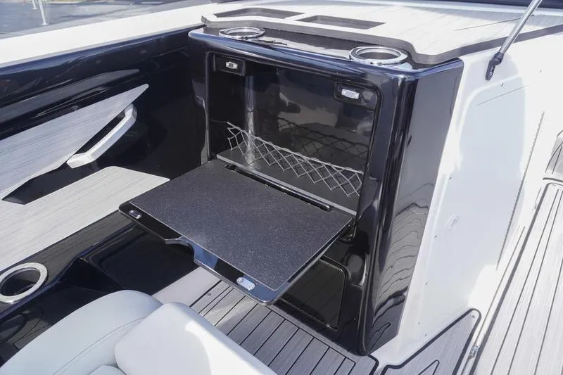 Slide: The Image of 2024 Yamaha Boats 222S interior with fold-out table and cup holders. - 29