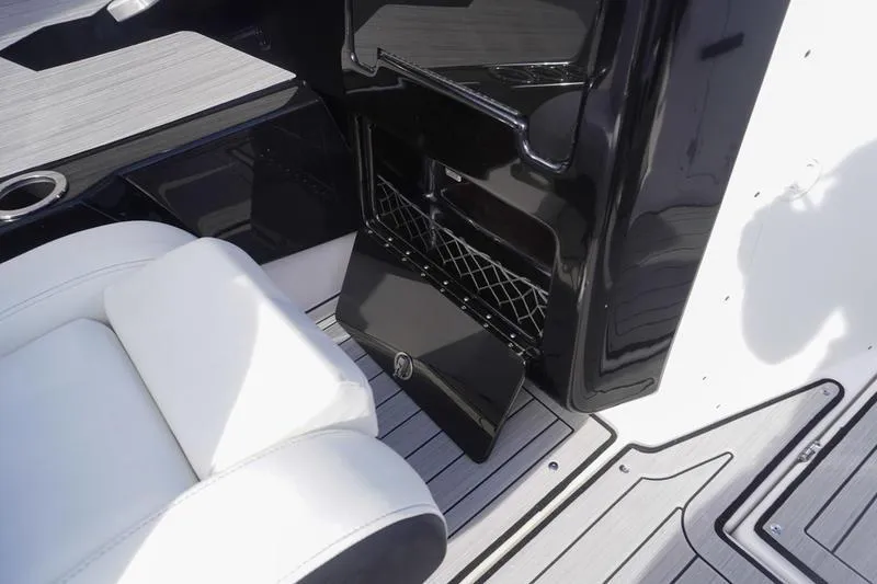 Slide: The Image of 2024 Yamaha Boats 222S interior with white seating and black storage compartment. - 30