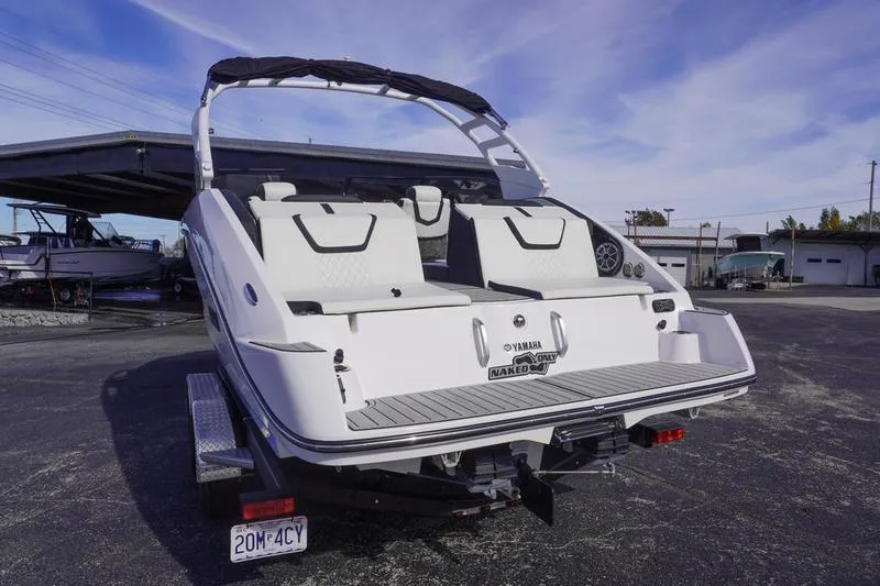 Slide: The Image of 2024 Yamaha Boats 222S, rear view, on trailer, outdoor setting, clear sky. - 4