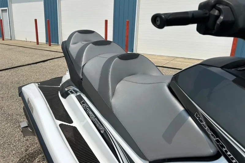Slide: The Image of 2015 Yamaha WaveRunner FX Cruiser HO with sleek gray seating, parked outdoors. - 4