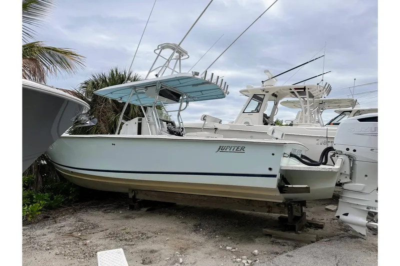Slide: The Image of 2005 Jupiter 31 Center Console boat on dry dock, surrounded by other vessels. - 1