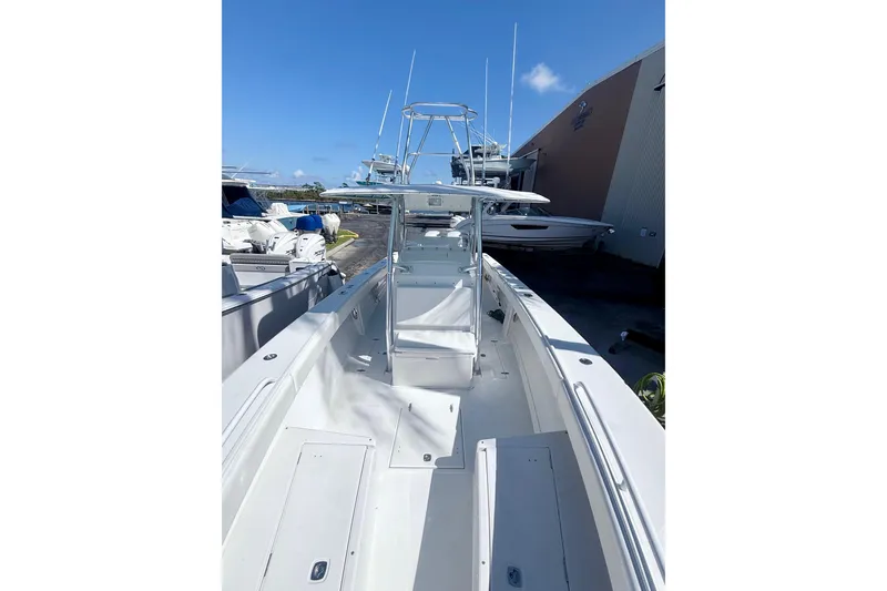 Slide: The Image of 2005 Jupiter 31 Center Console boat docked, showcasing spacious deck and modern design. - 12