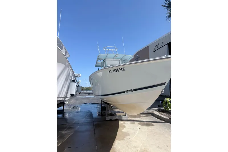 Slide: The Image of 2005 Jupiter 31 Center Console boat docked under clear blue sky. - 16