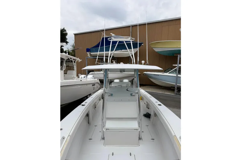 Slide: The Image of 2005 Jupiter 31 Center Console boat in a marina, surrounded by other vessels. - 7