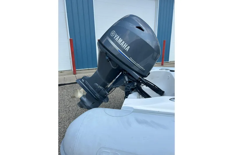 Slide: The Image of 2018 AB Inflatables Oceanus 4.30VSC with Yamaha outboard motor, parked near blue building. - 15