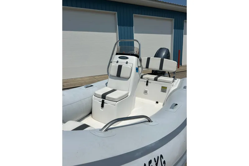 Slide: The Image of 2018 AB Inflatables Oceanus 4.30VSC boat with seating and console, docked near blue building. - 27