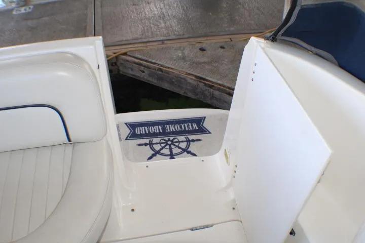 Slide: The Image of 2002 Bayliner 3055 Ciera boat interior with white seating and door. - 10