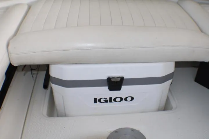 Slide: The Image of 2002 Bayliner 3055 Ciera boat interior with white seating and Igloo cooler. - 14
