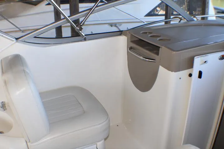 Slide: The Image of 2002 Bayliner 3055 Ciera boat interior with white seating and storage compartments. - 17