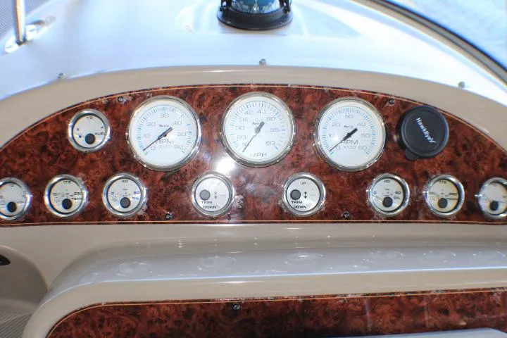 Slide: The Image of Dashboard of a 2002 Bayliner 3055 Ciera boat with gauges and Garmin display. - 22