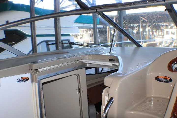 Slide: The Image of Interior view of a 2002 Bayliner 3055 Ciera boat cockpit with white seating. - 34
