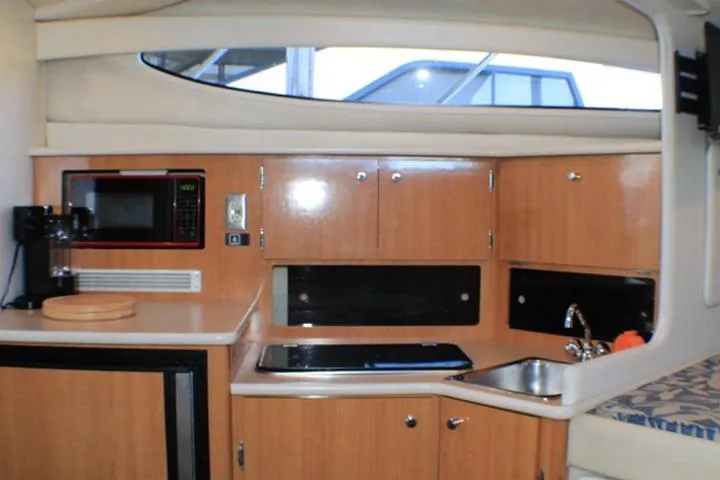 Slide: The Image of Interior of 2002 Bayliner 3055 Ciera boat with beige seating and floral cushions. - 41